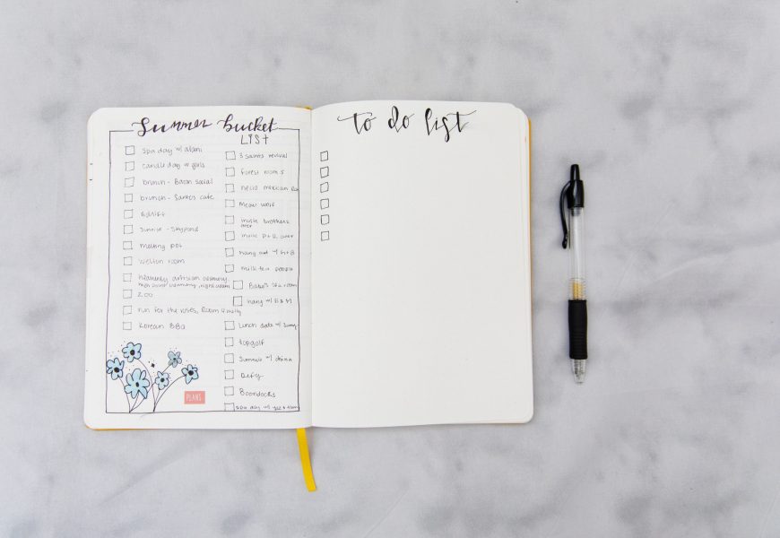 Bucket list and to do list on a journal on gray background